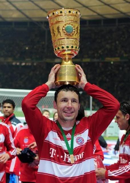 Mark celebrates with the DFB Pokal Trophy